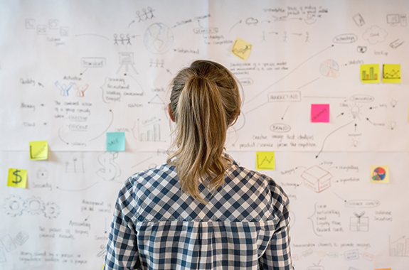 Woman sketching a business plan at a creative office Brand Strategy